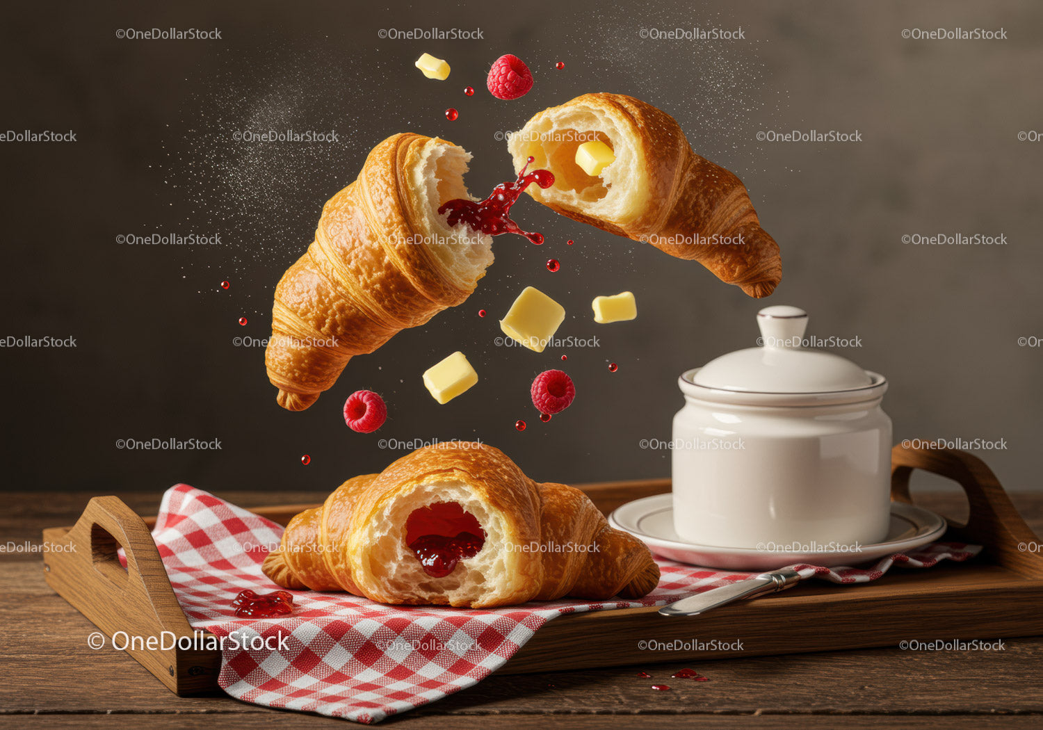 Fresh croissants with raspberry jam and butter on tray