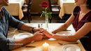 Couple Sharing Tender Moment During Romantic Dinner