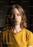 Portrait of a Young Woman with Blonde Hair in Casual Yellow T-Shirt