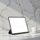 Modern tablet and coffee cup on marble countertop