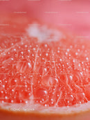 Close-up of Juicy Grapefruit Slice with Water Droplets