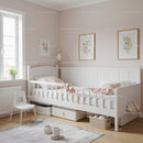 Bright and Cozy Children's Bedroom with White Crib and Floral Wall Art