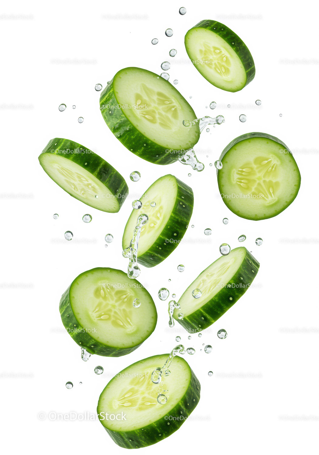 Fresh cucumber slices splashing in clear water
