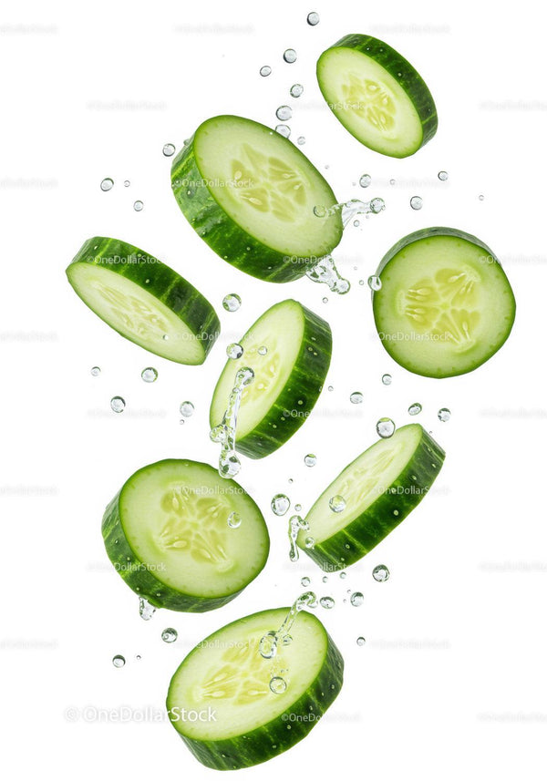 Fresh cucumber slices splashing in clear water