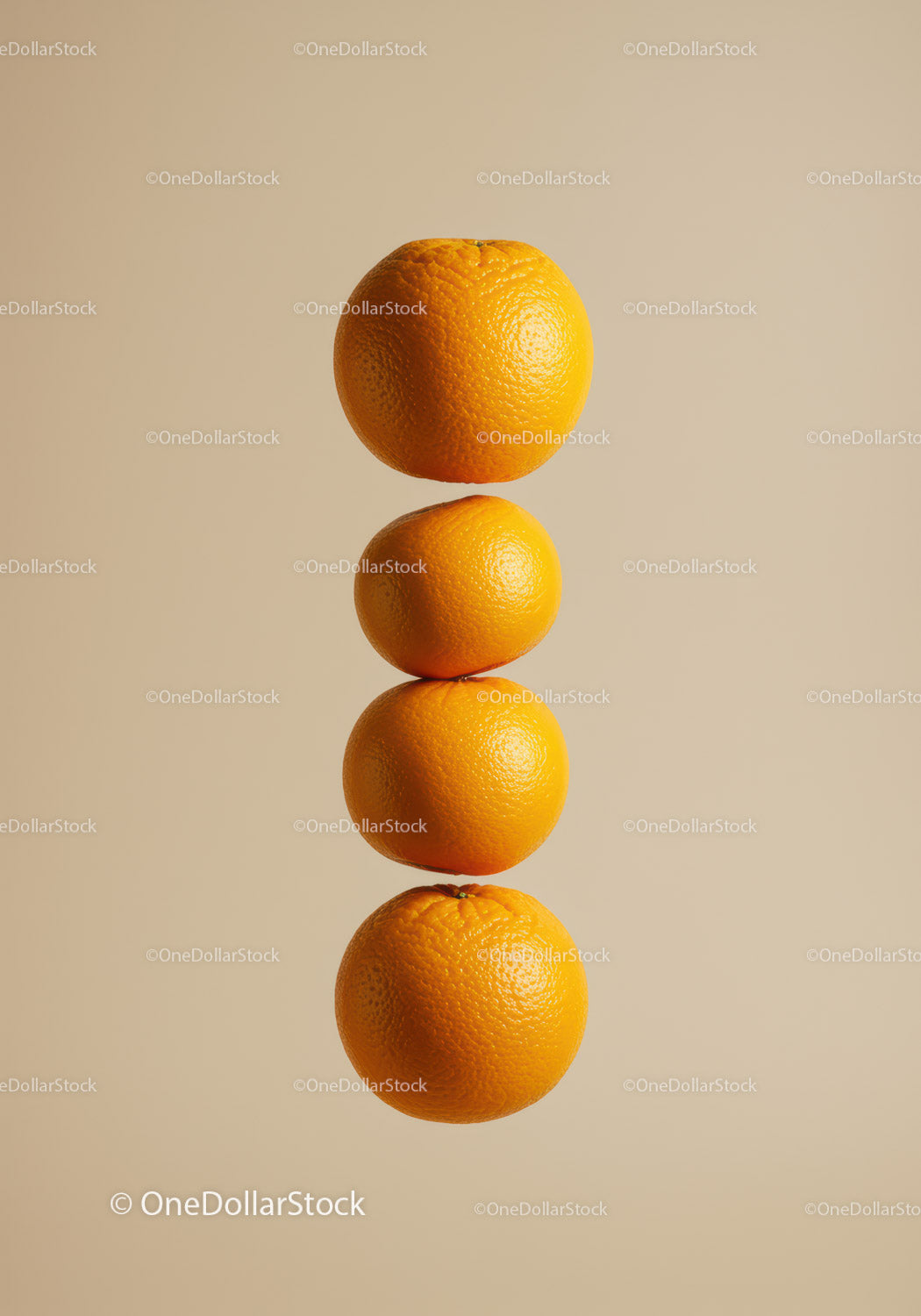 Four ripe oranges stacked vertically on beige background