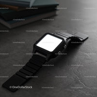 Modern black smartwatch on dark textured surface