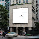 Urban street scene with large blank billboard on building