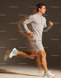 Athlete running indoors with focused expression