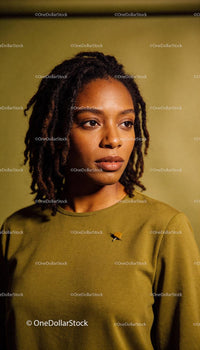 Contemplative young woman in olive green sweater