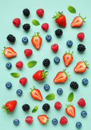 Variety of Fresh Berries and Mint Leaves on Blue Surface