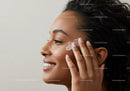 Woman Applying Skincare Cream for Glowing Skin