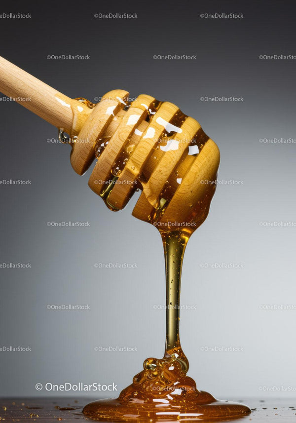 Close up of honey dripping from wooden dipper