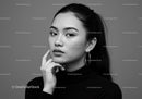 Elegant Black and White Portrait of a Woman with Hoop Earrings and Confident Expression