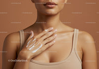 Close-Up of Woman in Beige Tank Top Applying Lotion on Shoulder