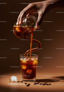 Pouring Cold Brew Coffee Over Ice Cubes in Glass