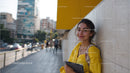 Young Woman Enjoying Urban Street Scene with Tablet