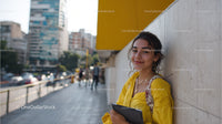 Young Woman Enjoying Urban Street Scene with Tablet