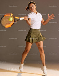 Female tennis player hitting fast forehand stroke indoors