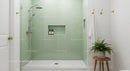 Modern bathroom shower with green tiled walls and plant
