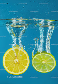 Lemon and lime slices splashing in clear water