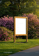 Wooden signboard in vibrant park with blooming flowers
