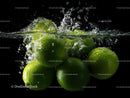Fresh Green Limes Splashing into Water with Bubbles on Black Background