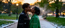 Couple Sharing a Tender Kiss in Snowy Park at Sunset