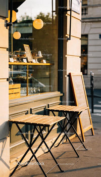 Empty street cafe tables bathed in warm afternoon light