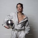 Stylish Woman in Metallic Outfit Holding Disco Ball for Modern Fashion