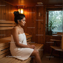 Woman Relaxing in Wooden Sauna Room with Towel and Calm Atmosphere