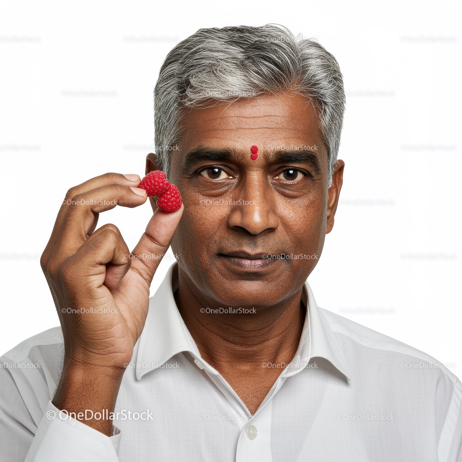 Mature Man Enjoying Fresh Raspberries with Natural Expression