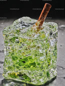 Close Up of Green Leaf Frozen in Ice Cube with Stem
