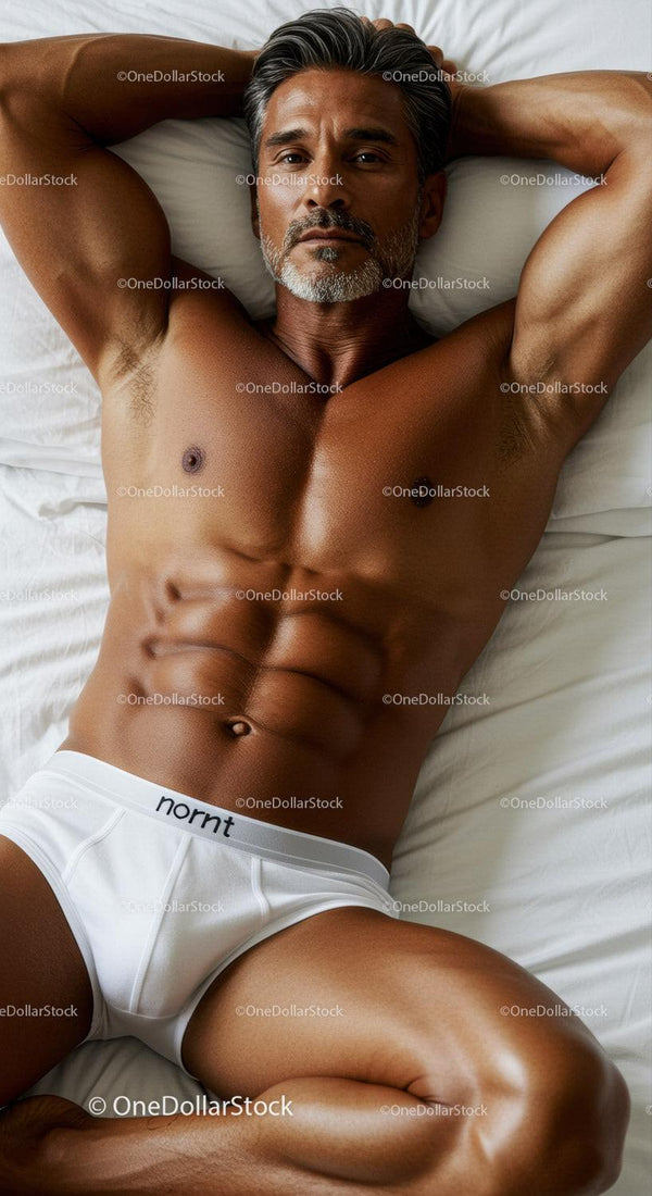 Fit mature man relaxing on bed in white underwear