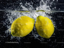 Yellow Lemons Splashing Under Water in Fresh and Vibrant Scene