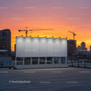 Modern Rooftop Billboard with City Skyline at Sunset Sky