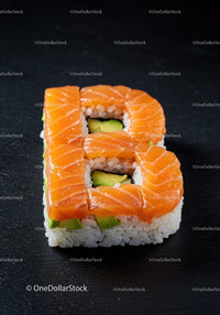 Sushi roll shaped like the letter B with salmon