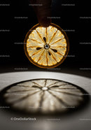 Close up of illuminated dried citrus slice held by fingers