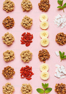Healthy snack ingredients arranged on pastel background
