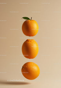 Three fresh oranges suspended on warm beige background