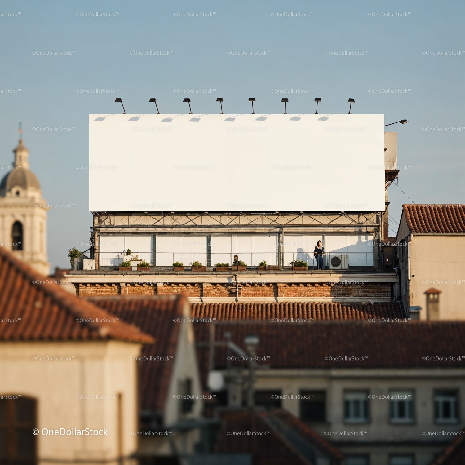 Urban rooftop terrace with large blank billboard in daylight