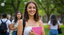 Happy Young Woman in Summer Outdoors Holding Pink Notebook