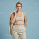 Stylish Young Woman in Beige Tank Top and Cream Trousers Against Light Blue Background