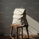 Minimalist beige backpack on rustic wooden stool