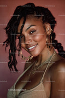 Joyful Smiling Woman with Braids and Golden Jewelry Portrait