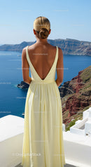 Woman in flowy dress admiring serene ocean view