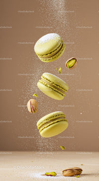 Pistachio macarons with powdered sugar falling