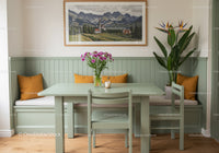 Pastel Green Dining Area with Wooden Chairs and Floral Decor