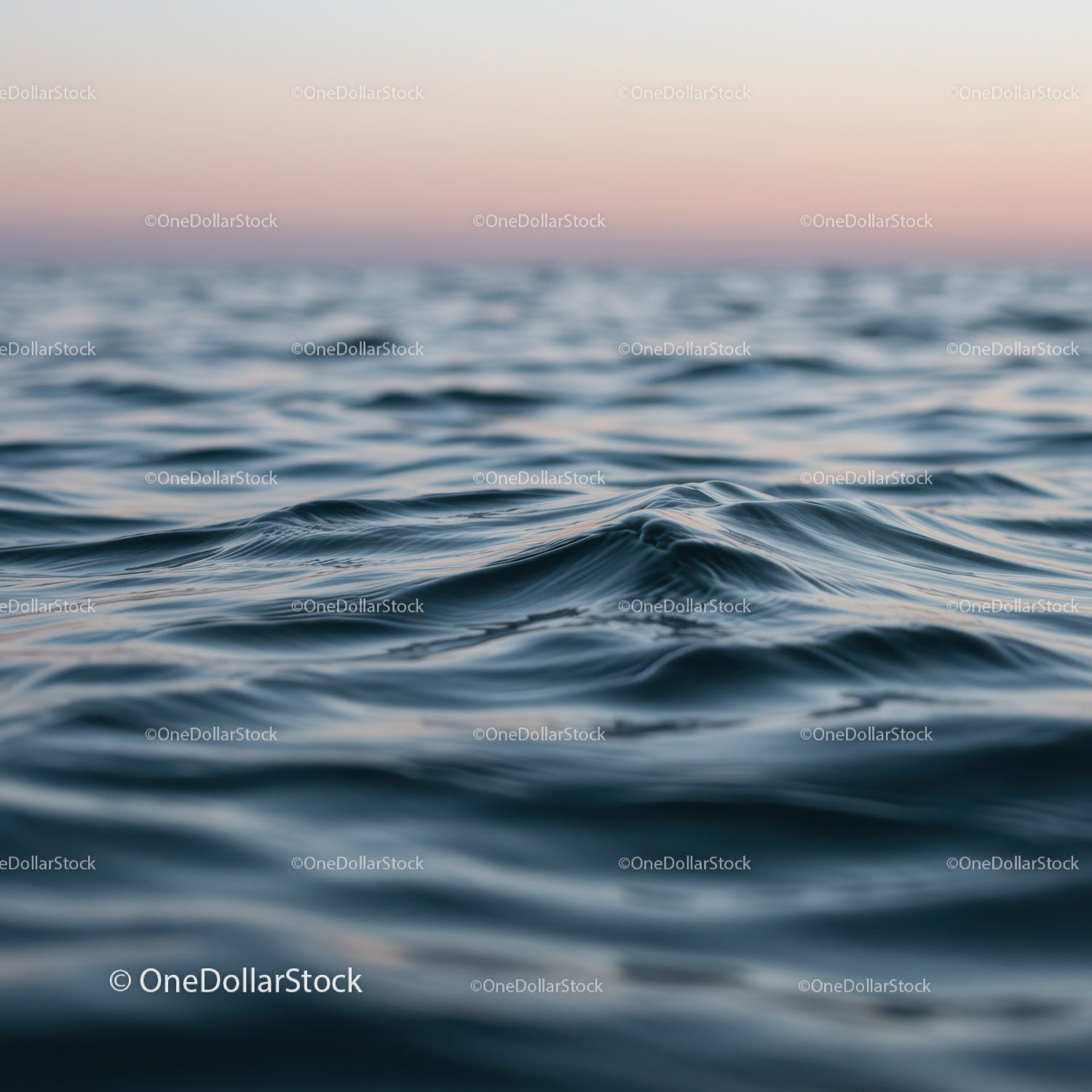 Serene Ocean Surface with Gentle Waves at Sunset