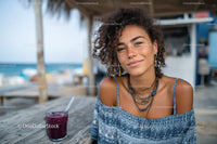 Young Woman Enjoying Refreshing Purple Drink at Beachside Cafe
