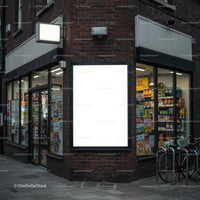 Bright blank billboard on urban store corner at dusk